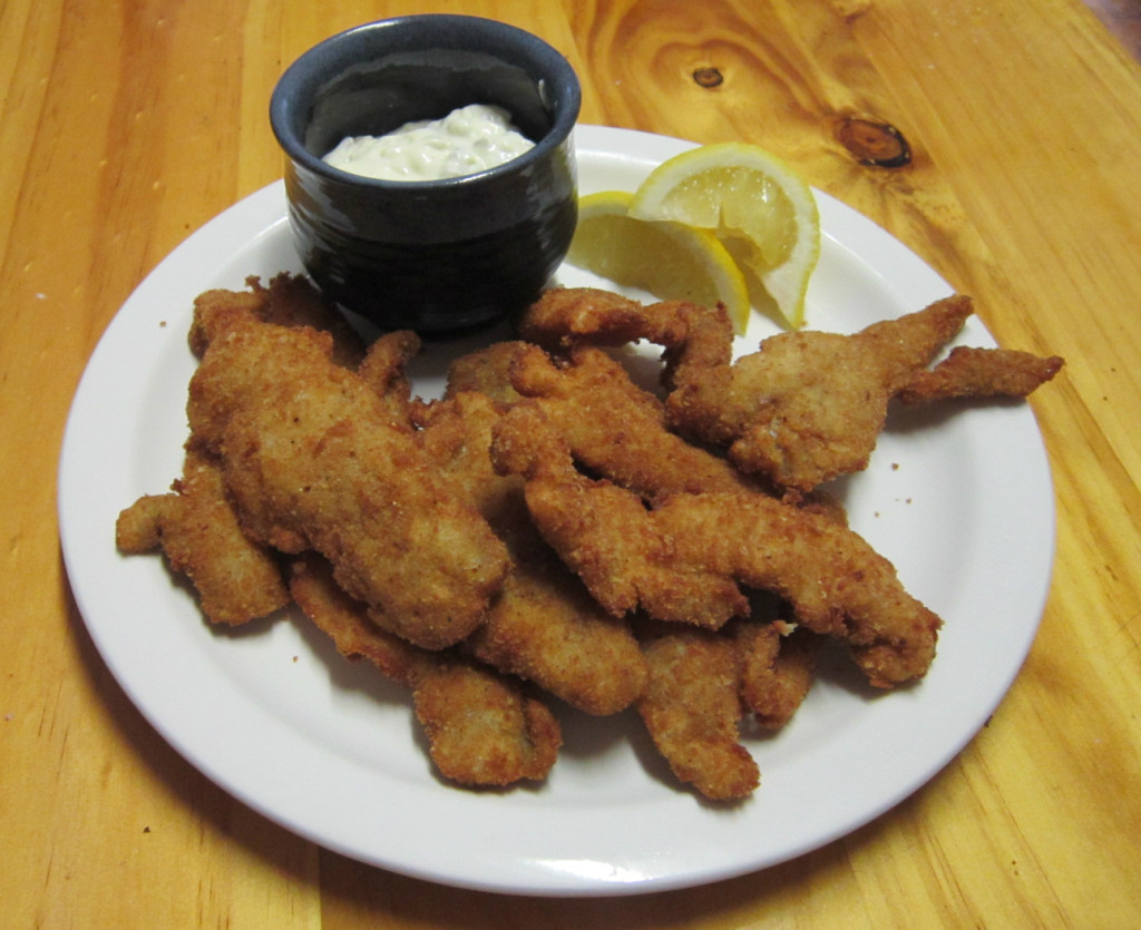 A plate of crispy fried pollock after a day of fishing in the rain.